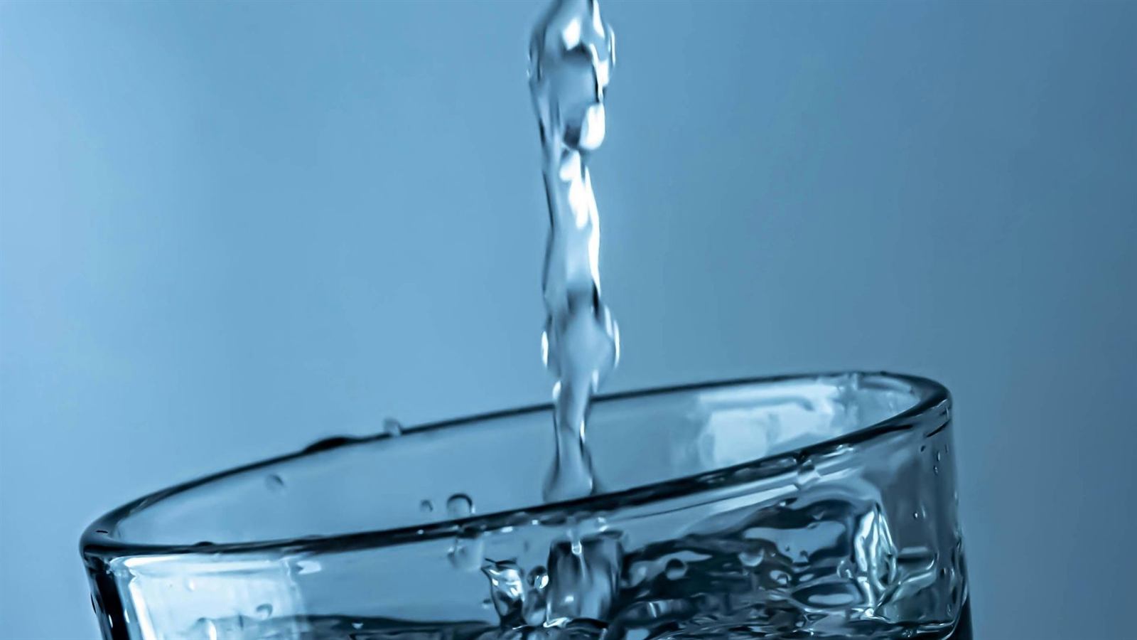 Clean well water pouring into a glass in Summerfield, NC