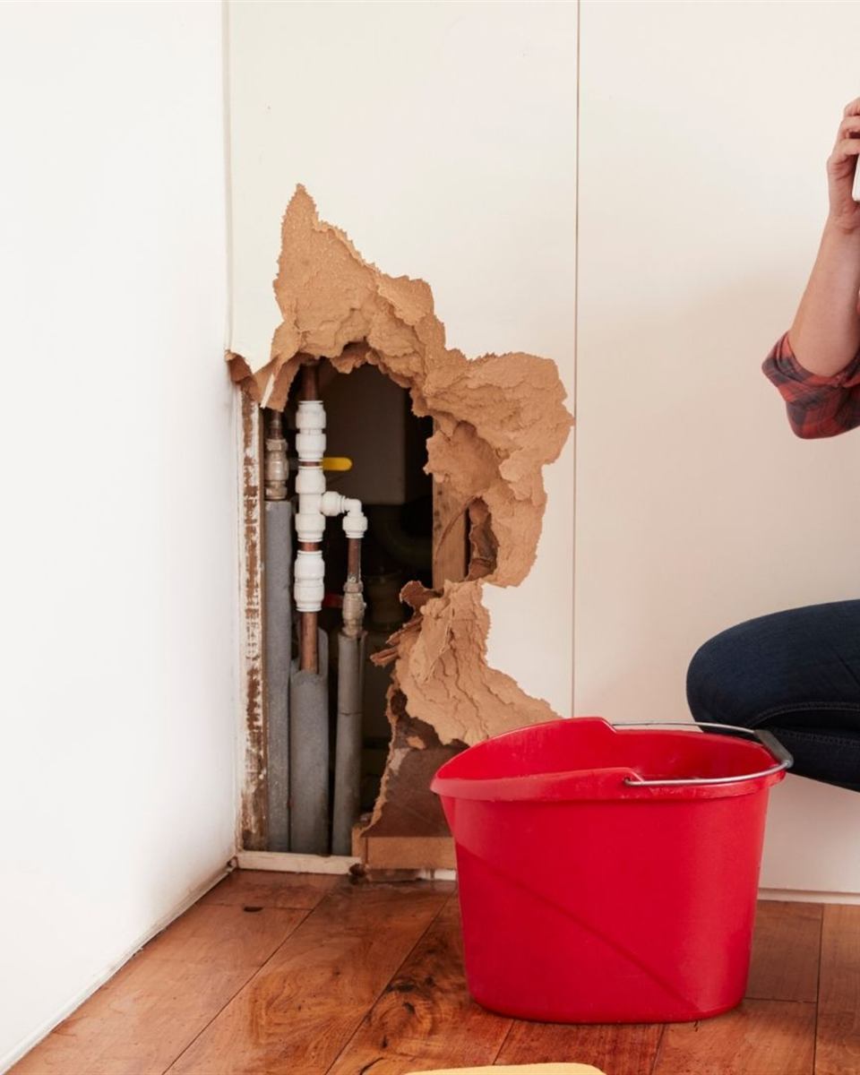 Homeowner closing the main water shutoff valve in a Reidsville crawl space home