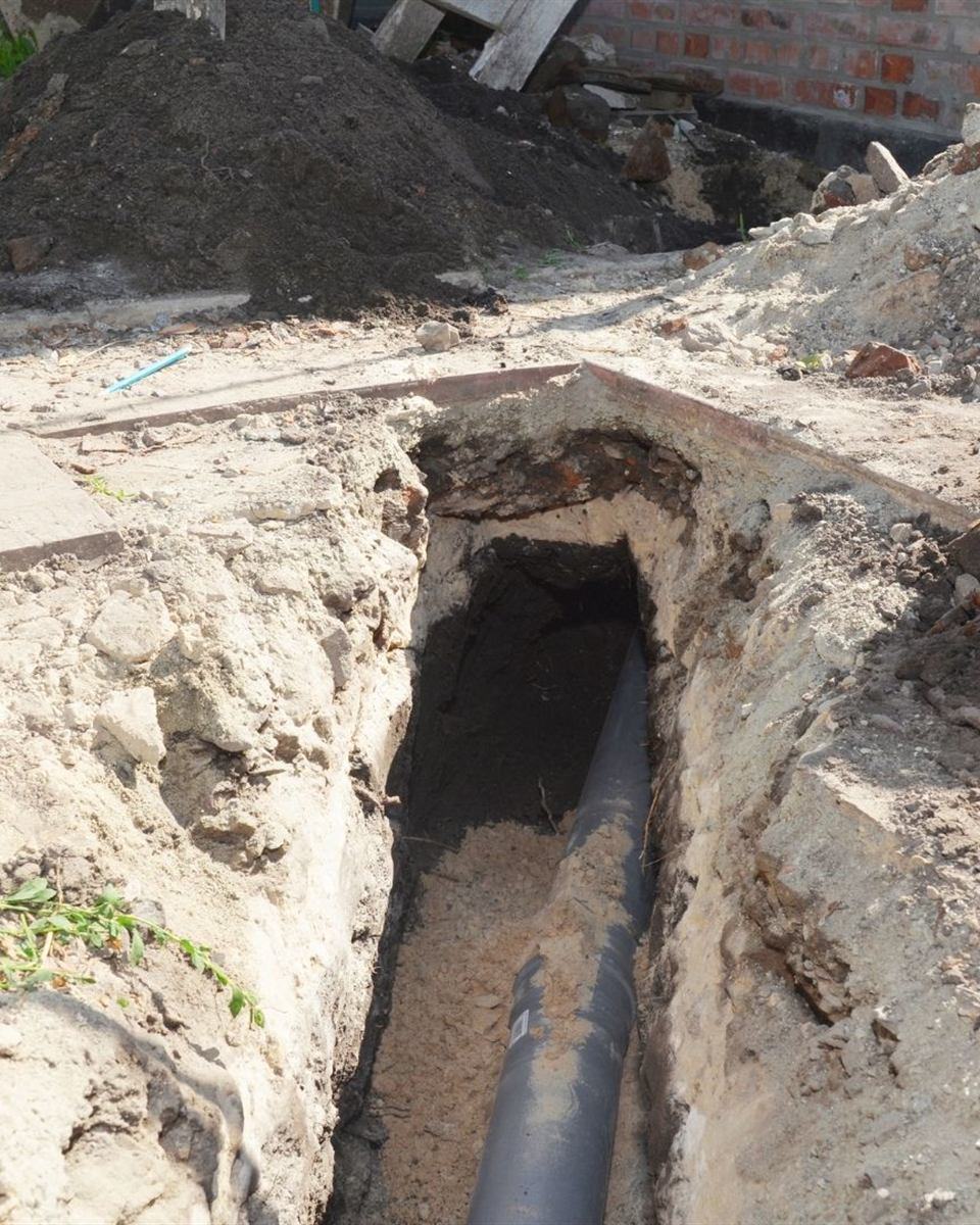 Central Piedmont Plumbing camera head entering a sewer cleanout for a video pipe inspection