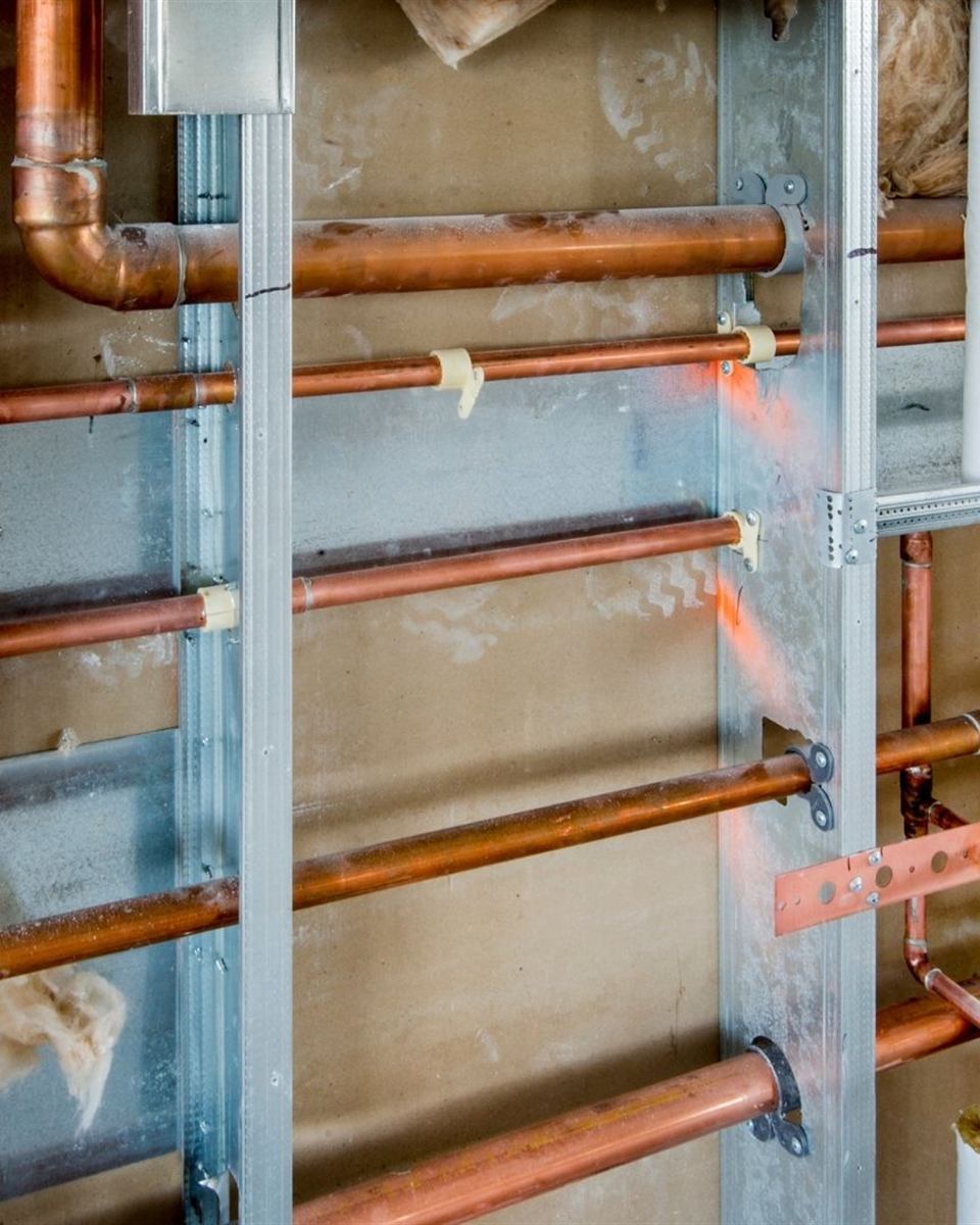 PEX manifold and new water lines installed during a repipe in a Rockingham County crawl space home