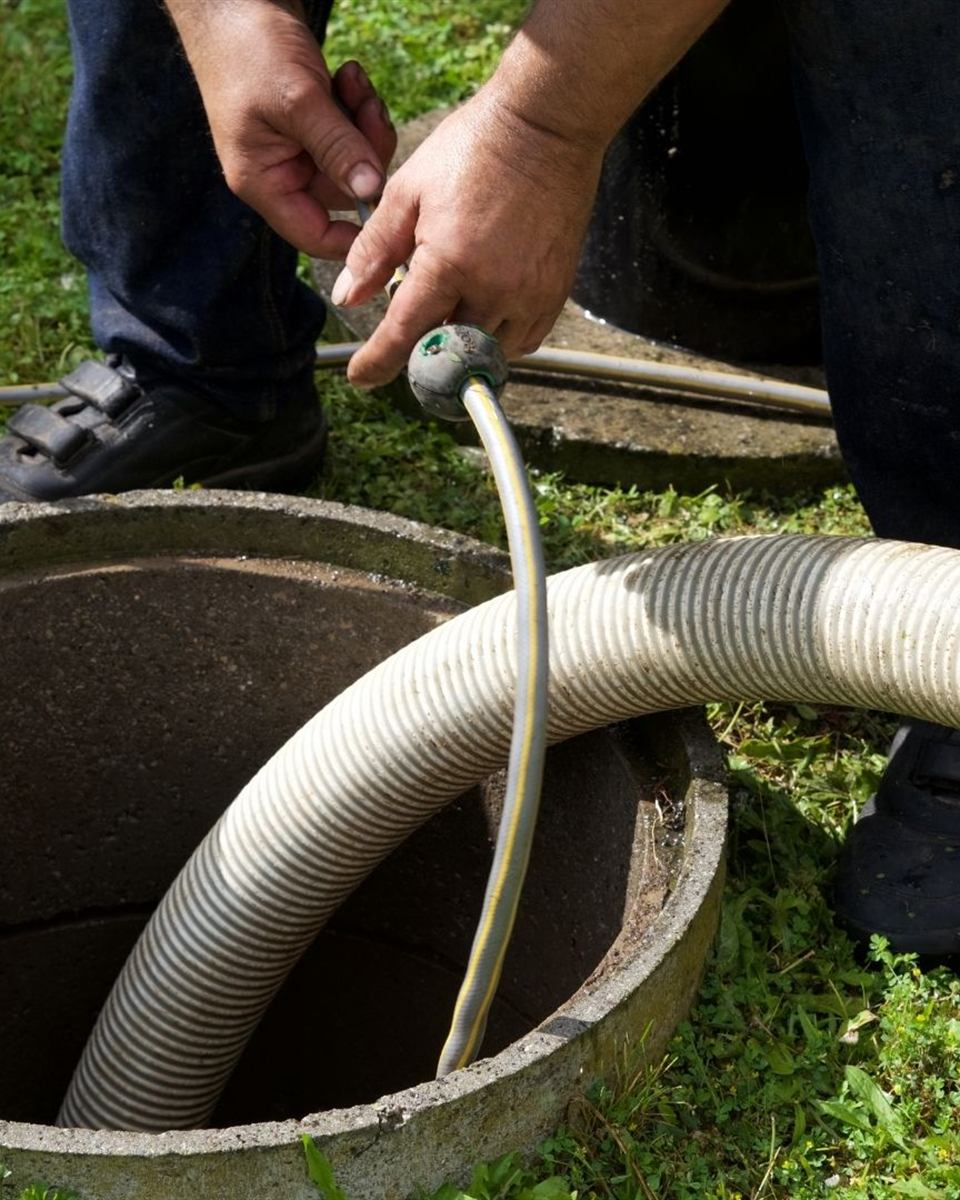 Float switches and control wiring being checked during a septic pump replacement in Rockingham County