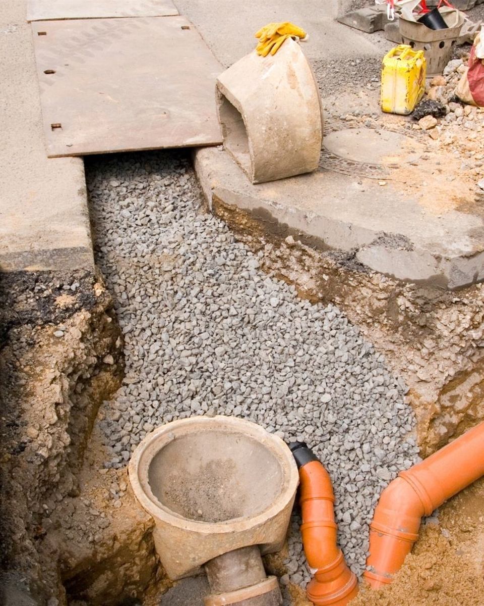 New PVC sewer main laid in red clay soil during a replacement near Reidsville