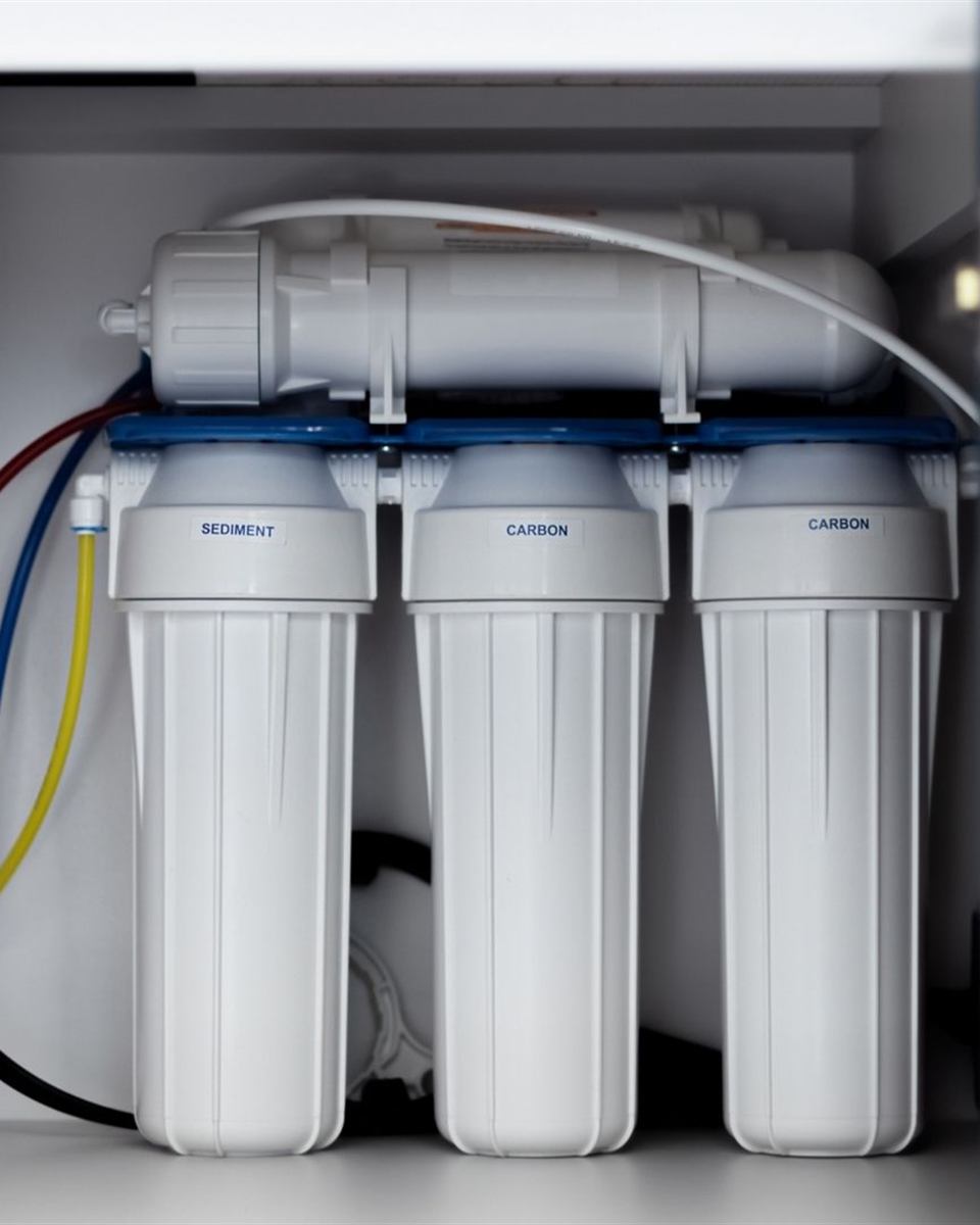 Whole-house sediment and carbon filter housings on a home's main water line near Reidsville