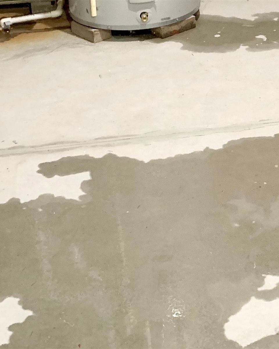 Plumber checking the air filter and controls on a heat-pump water heater