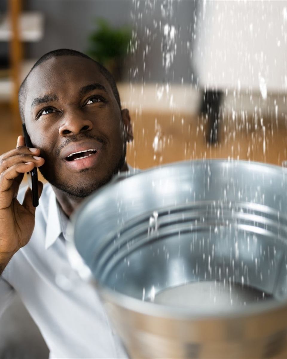 Homeowner waiting by the phone for a distant plumbing company to arrive