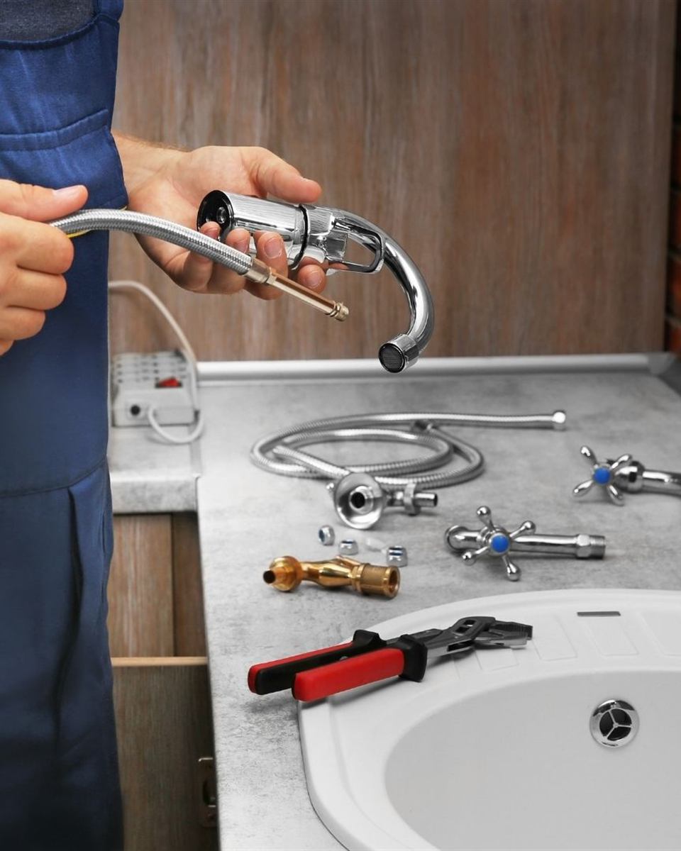 Faucet parts and tools laid out during a Central Piedmont installation
